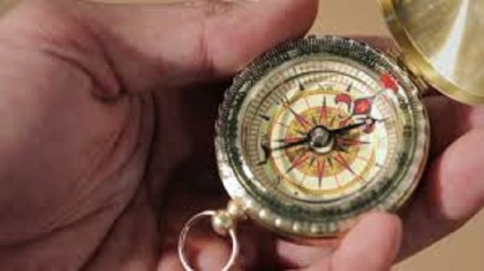 hand holding a compass